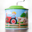 Small tin music instrument with farm motive