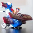 Tumbling plane tin toy