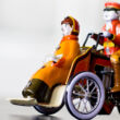 Tin Tricycle with passenger warm coloured