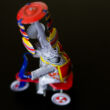 Kid elephant juggler on tricycle